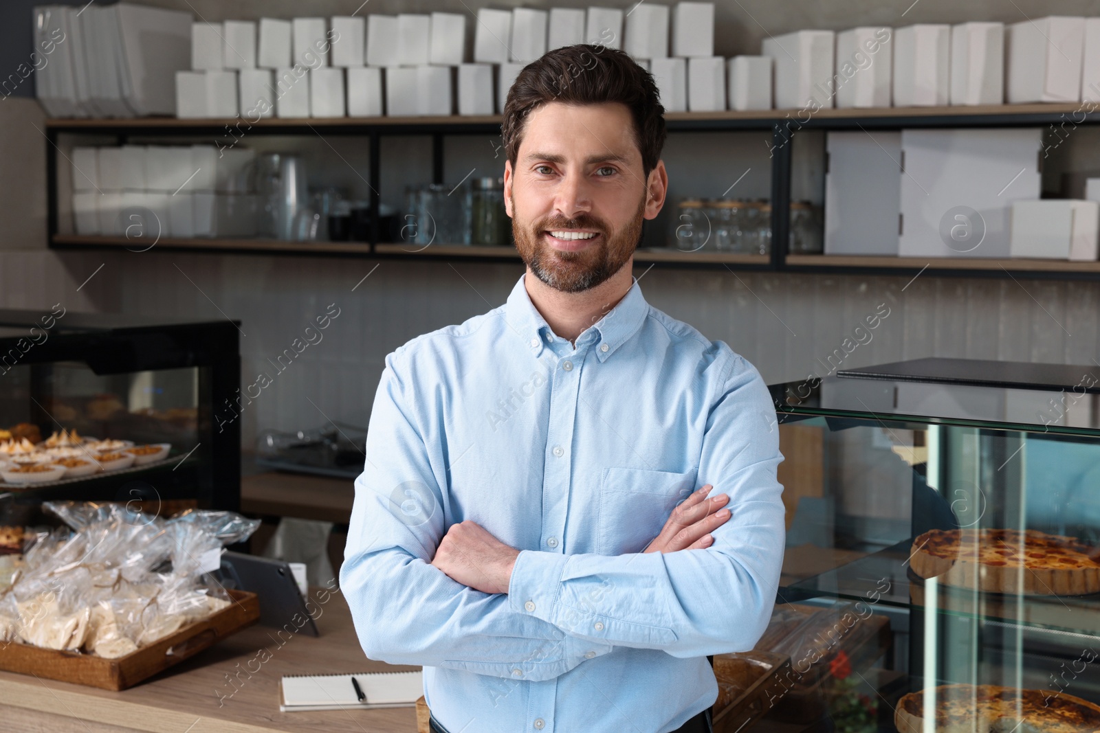 Photo of Portrait of happy business owner in bakery shop