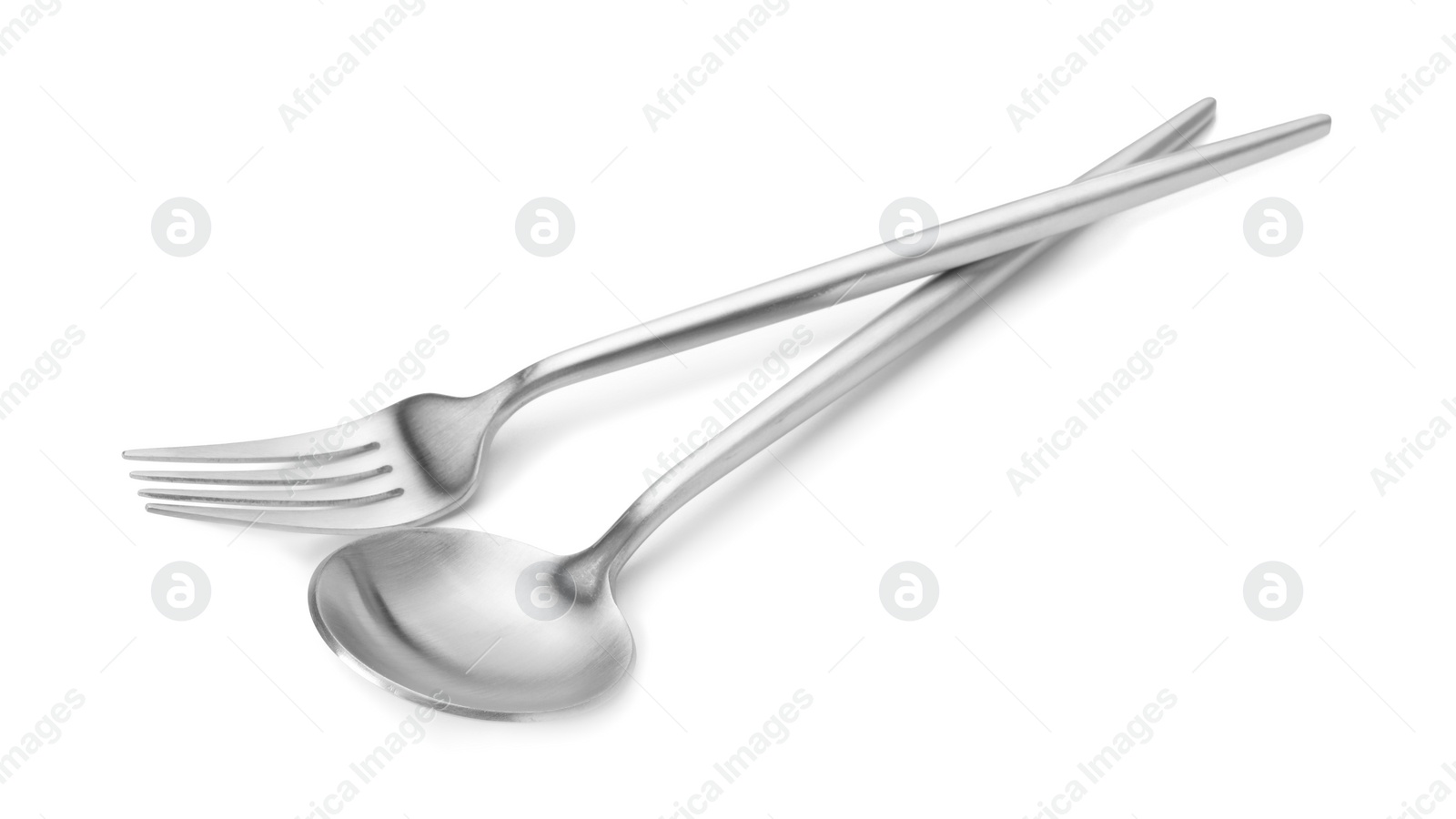 Photo of Shiny silver fork and spoon isolated on white. Luxury cutlery