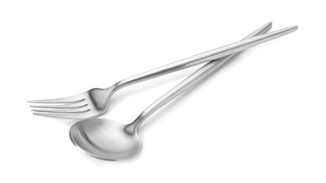 Photo of Shiny silver fork and spoon isolated on white. Luxury cutlery