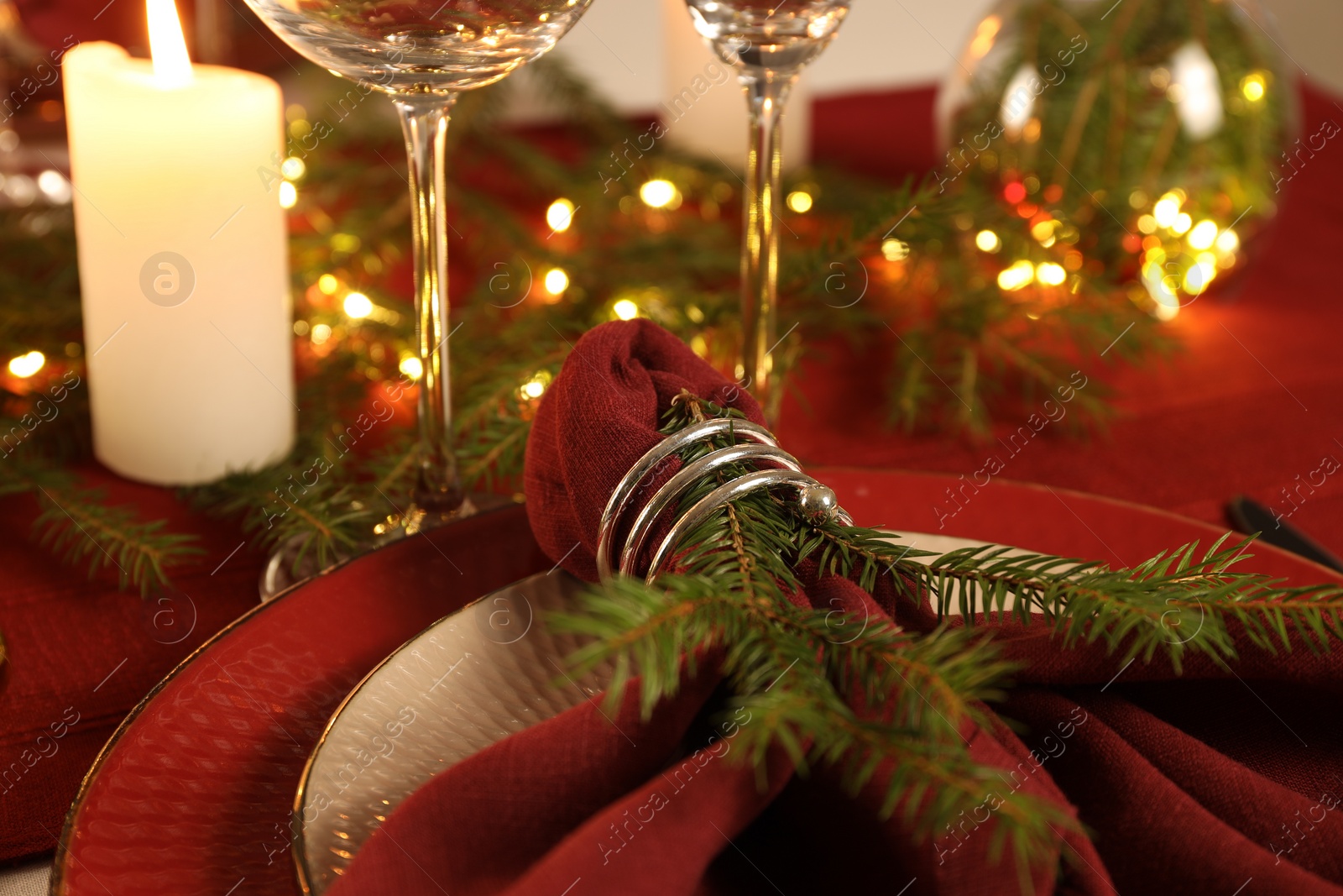 Photo of Christmas place setting with festive decor on table, closeup