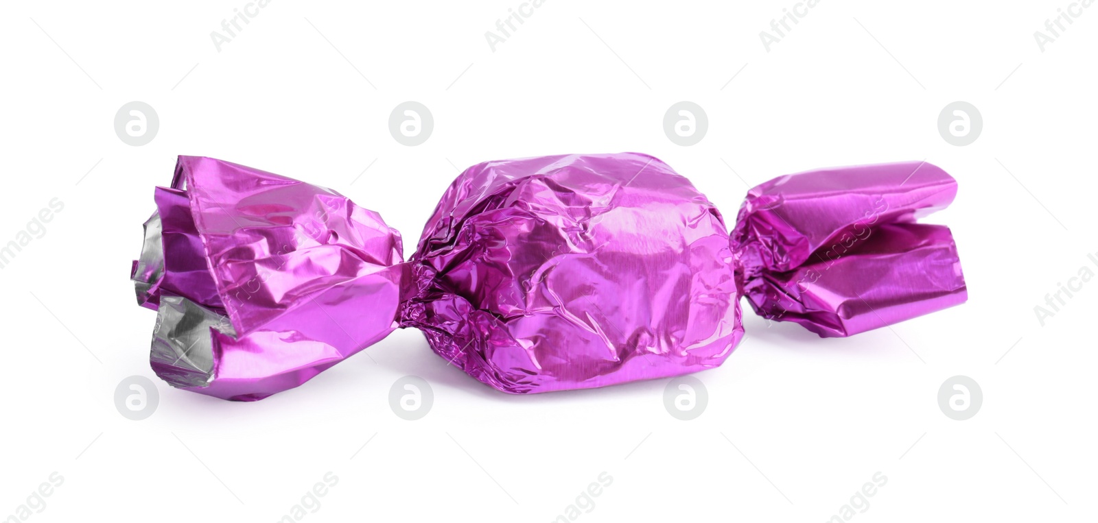 Photo of Tasty candy in violet wrapper isolated on white