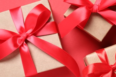 Beautiful gift boxes on red background, flat lay