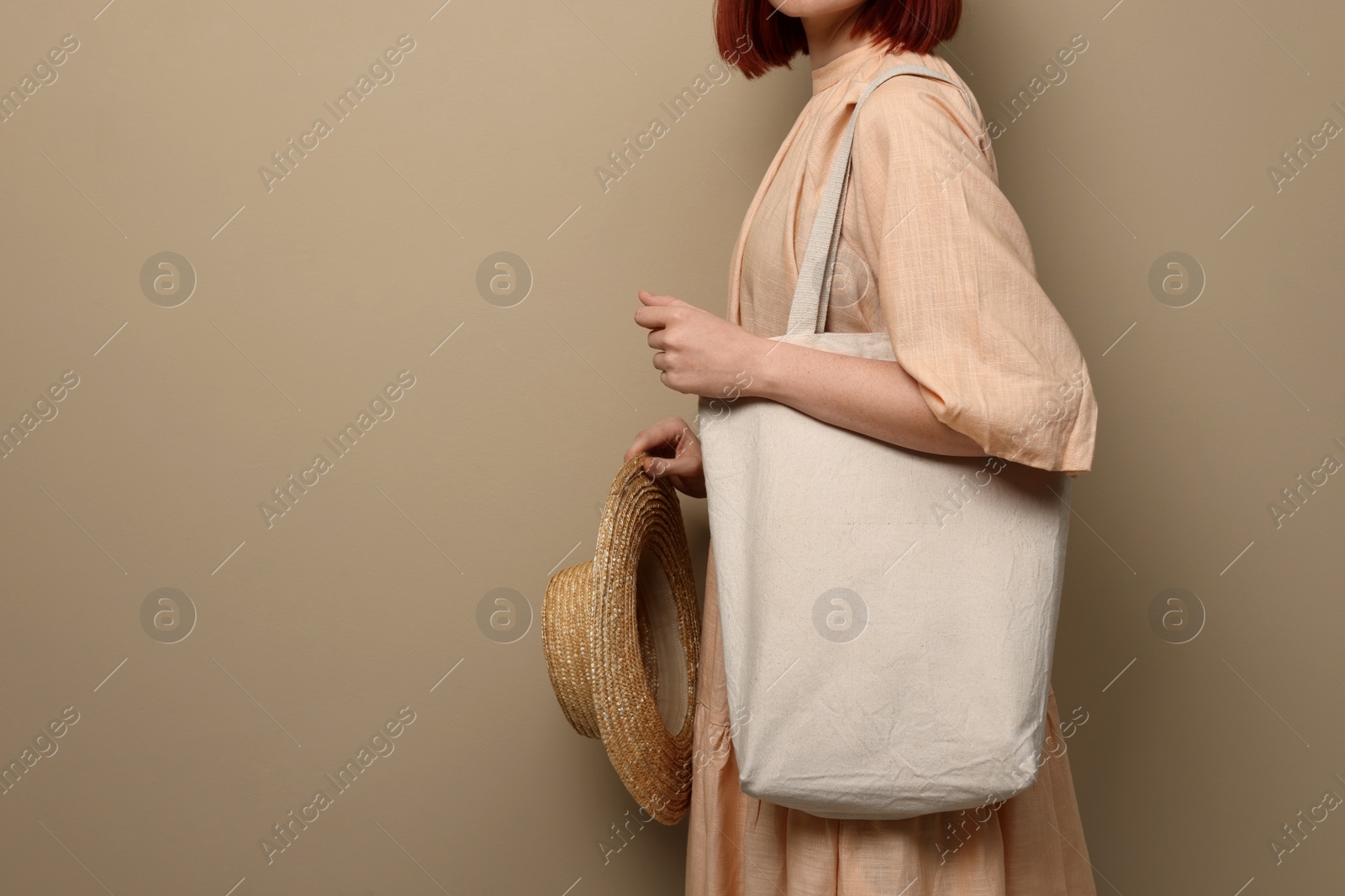 Photo of Woman with eco bag on beige background, closeup. Space for text