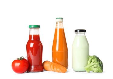 Photo of Bottles with different drinks and ingredients on white background