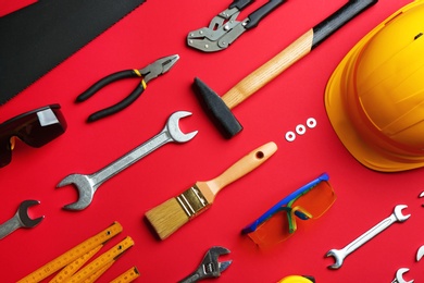 Photo of Flat lay composition with construction tools on color background