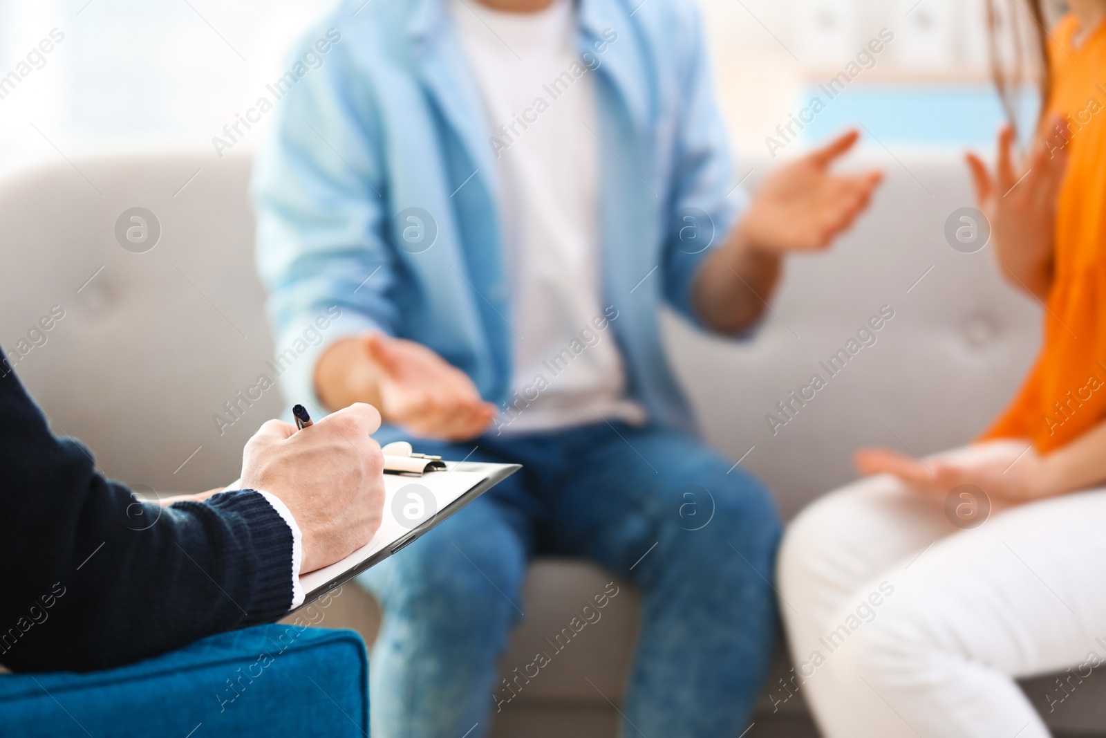 Photo of Family psychologist working with young couple in office, closeup