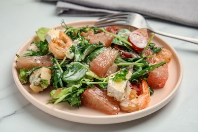 Photo of Delicious pomelo salad with shrimps served on white table, closeup