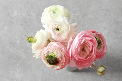 Photo of Beautiful ranunculus flowers on light background