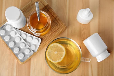 Flat lay composition with different cold remedies on wooden table