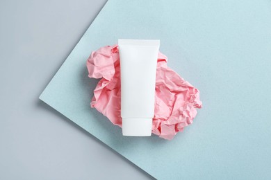 Photo of Tube of hand cream on color background, top view