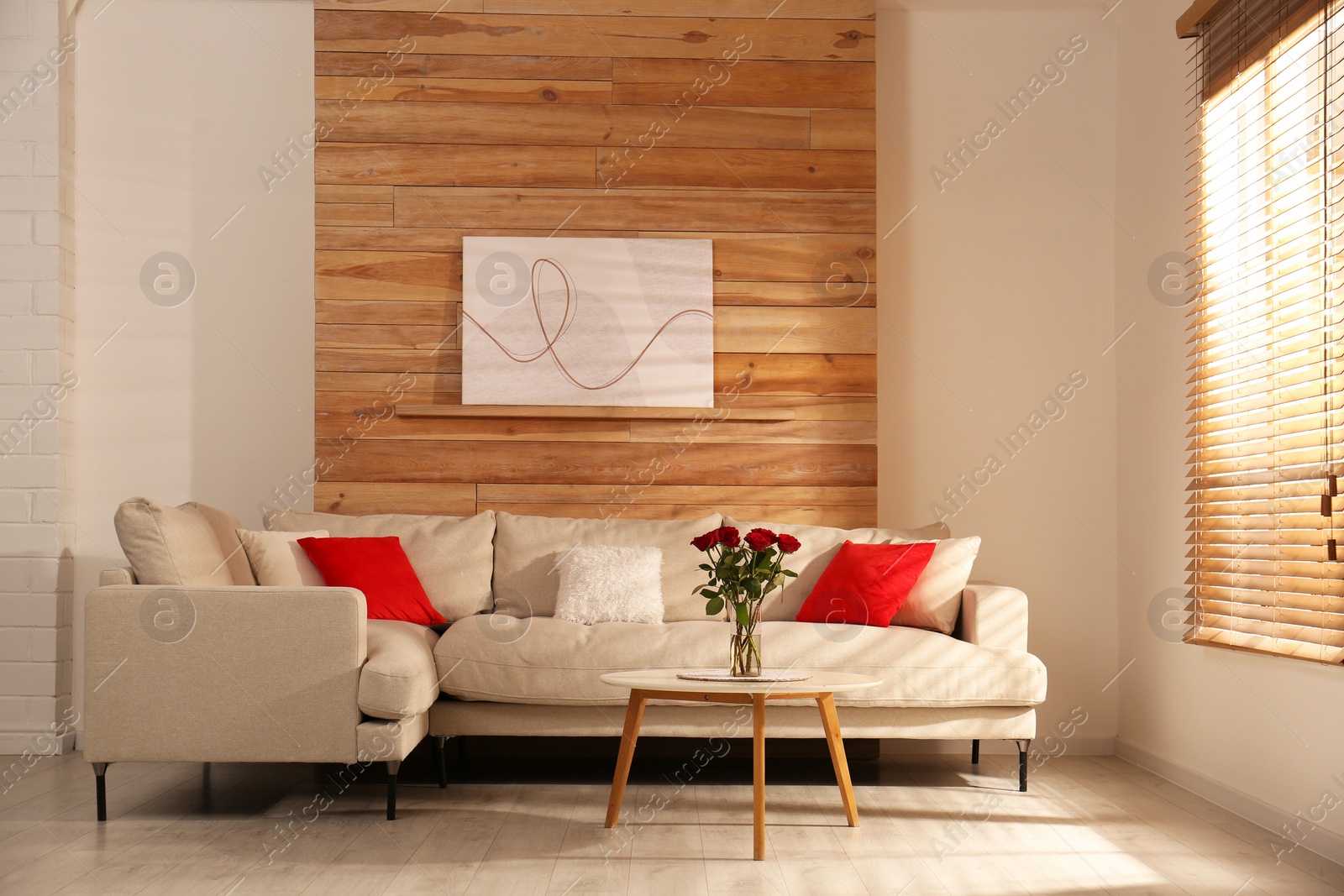 Photo of Modern comfortable sofa near wall in room. Interior design