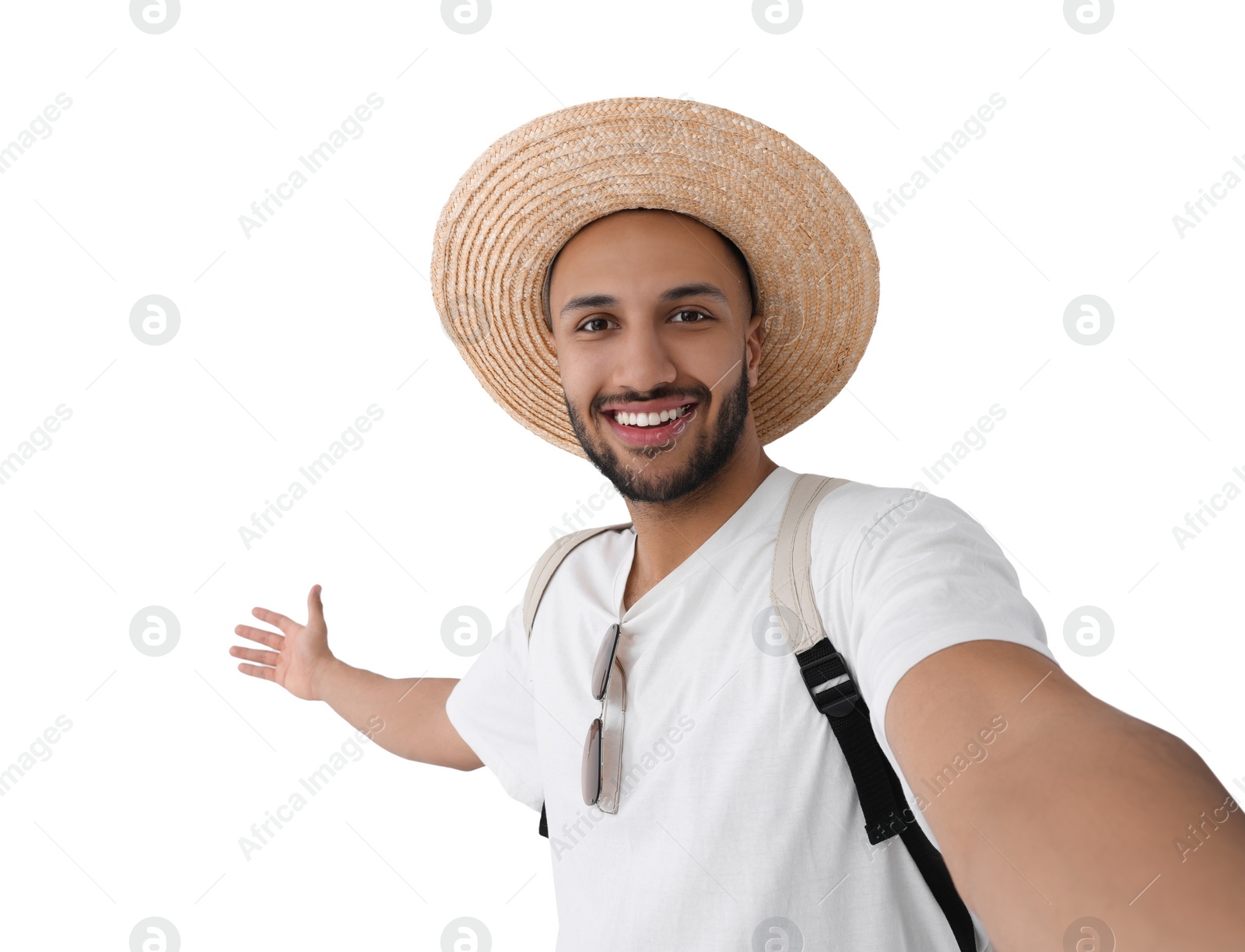 Photo of Smiling young man in straw hat taking selfie on white background