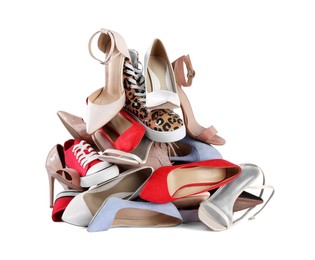 Photo of Pile of different female shoes isolated on white