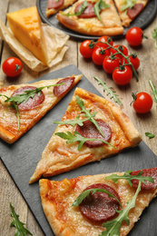 Photo of Tasty pepperoni pizza with arugula on wooden table