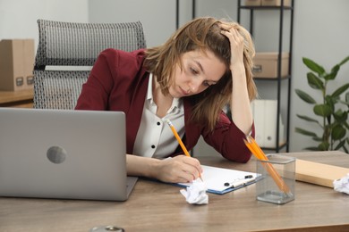 Photo of Sad businesswoman working at wooden table in office