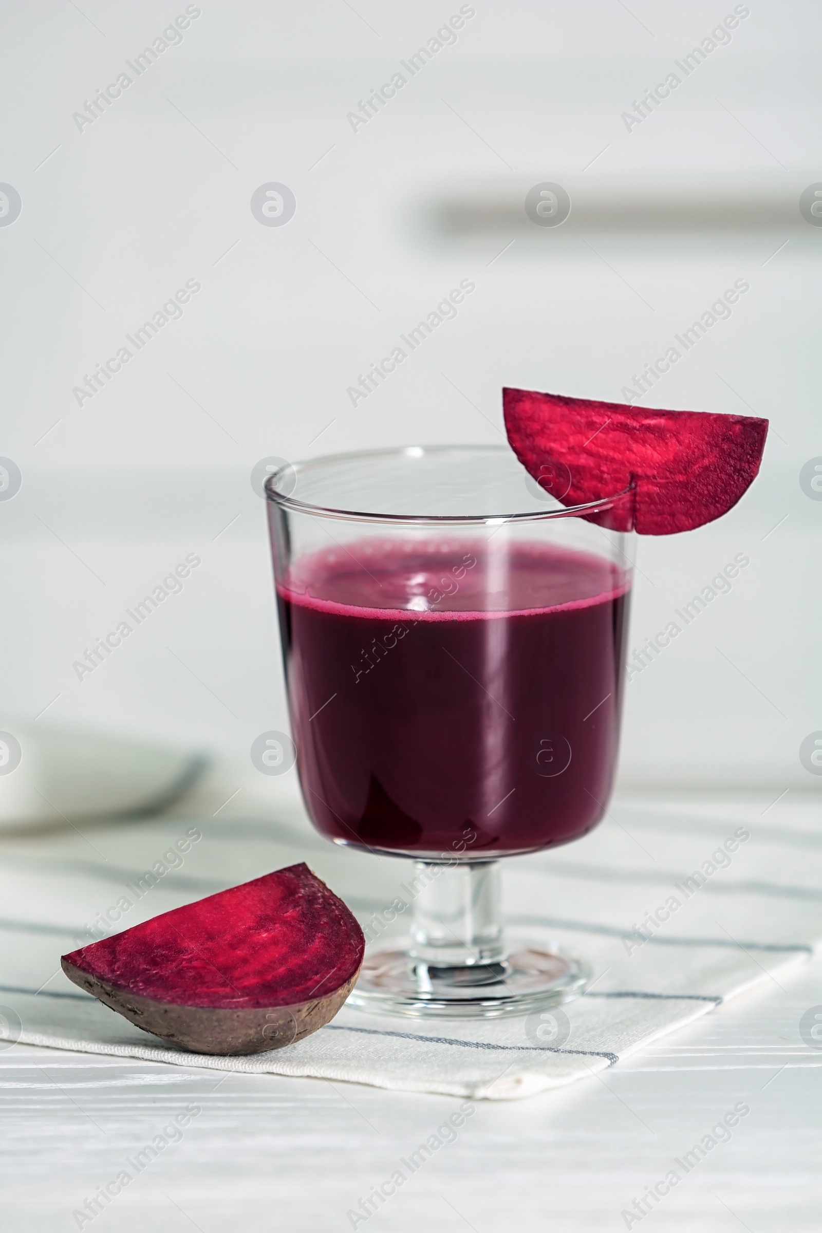 Photo of Glass of tasty beet smoothie on table