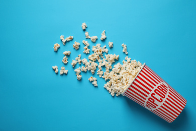 Photo of Delicious popcorn on light blue background, top view