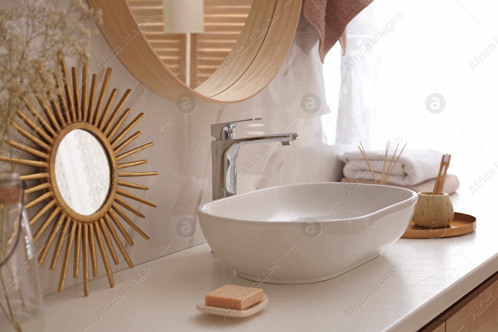 Photo of Stylish vessel sink under mirror in bathroom. Interior element