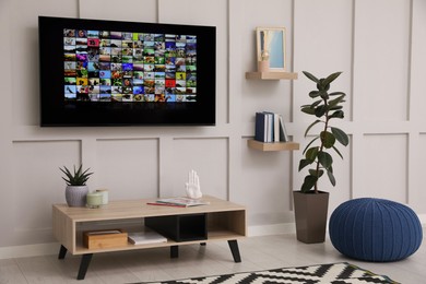 Stylish living room interior with modern TV on white wall