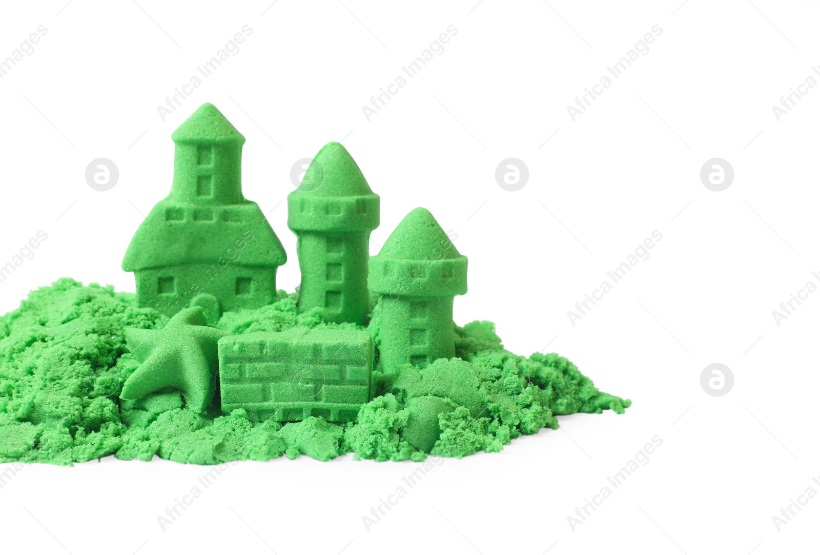 Photo of Castle figures and starfish made of green kinetic sand isolated on white