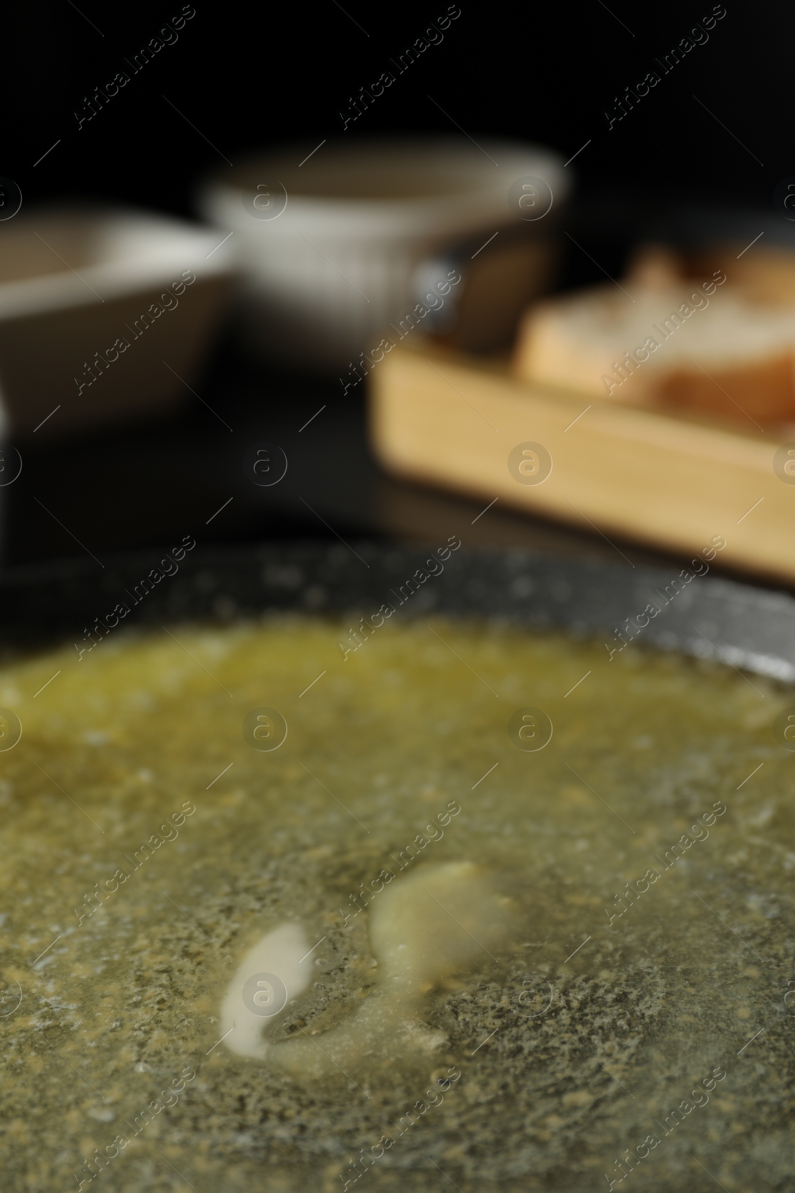 Photo of Melted butter in frying pan, closeup view