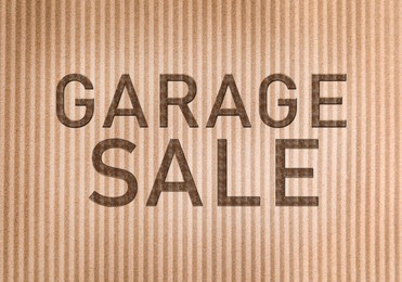 Words Garage Sale on corrugated cardboard, top view