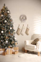 Beautiful decorated Christmas tree in festive room interior