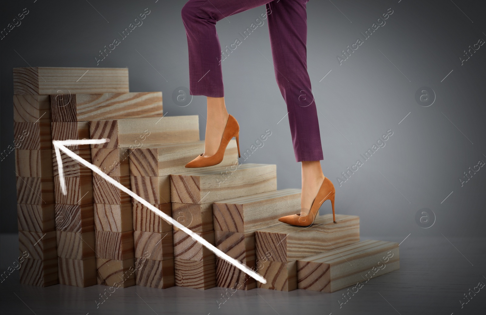 Image of Businesswoman walking up stairs against grey background, closeup. Career ladder concept