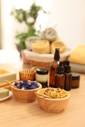 Photo of Dry flowers on wooden table indoors, space for text. Spa time