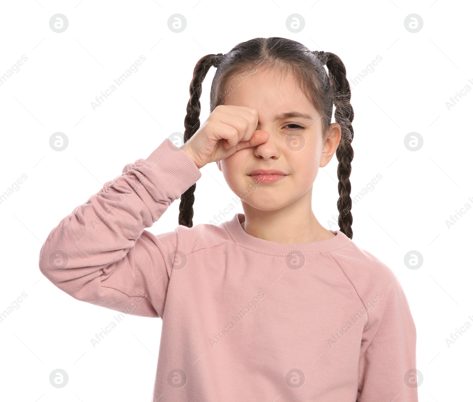 Photo of Little girl rubbing eye on white background. Annoying itch