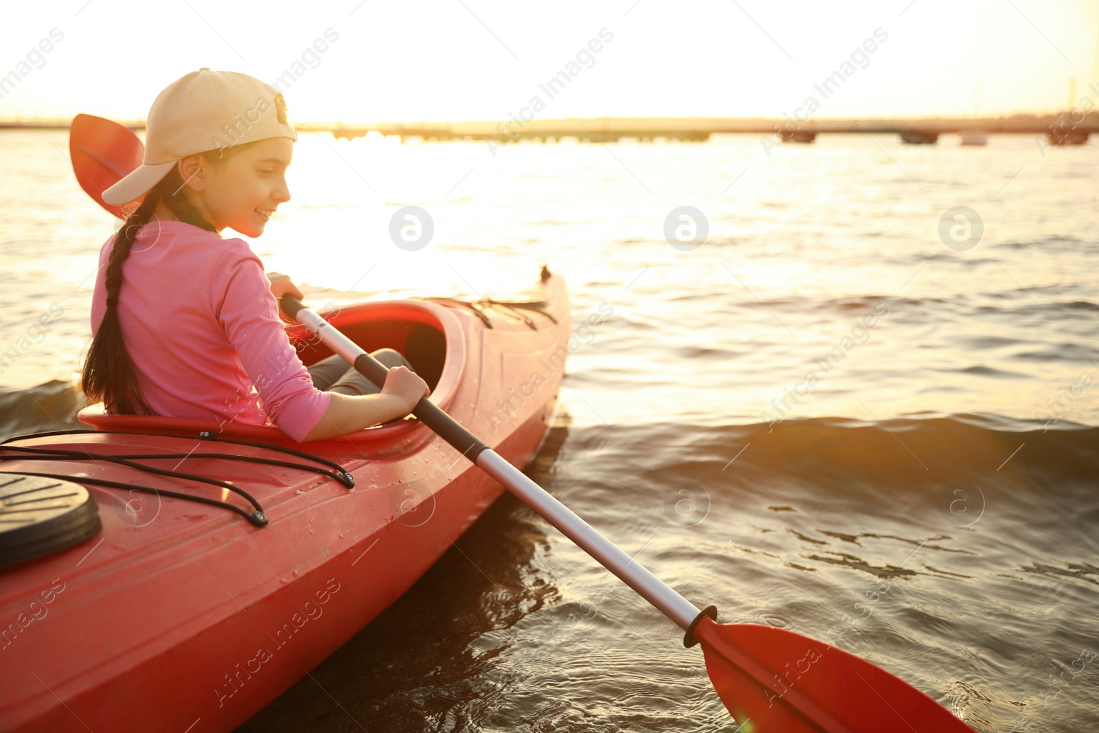 Photo of Happy girl kayaking on river. Summer camp activity