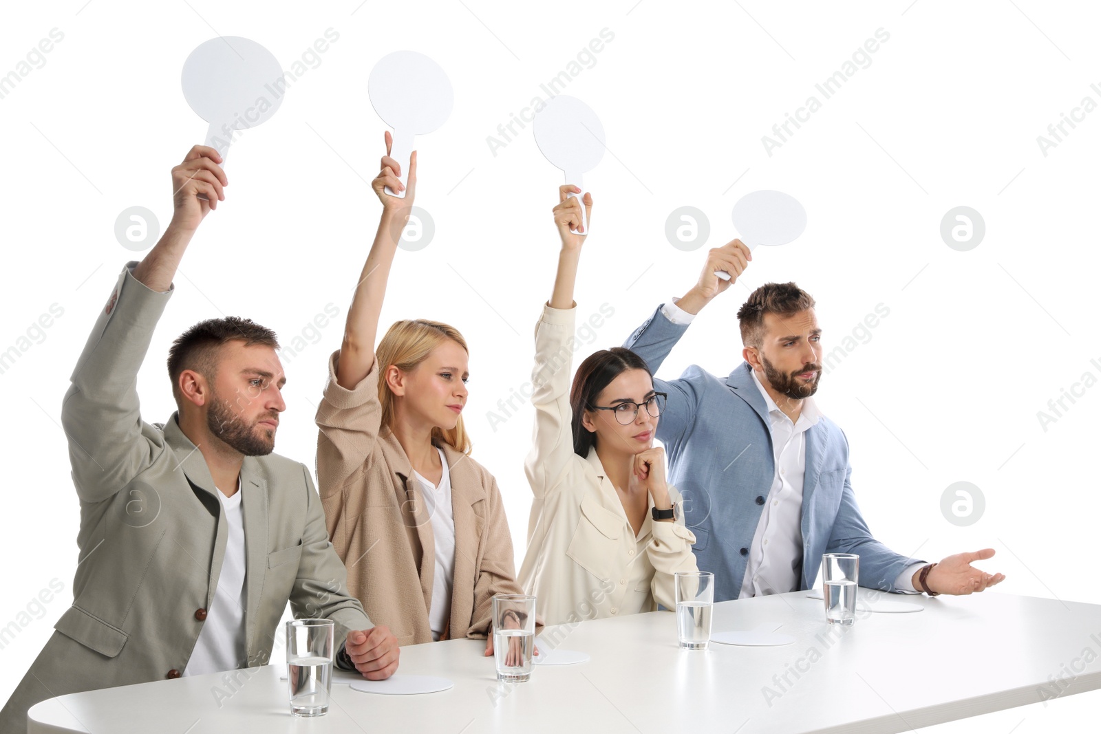 Photo of Panel of disappointed judges holding blank score signs at table on white background. Space for text