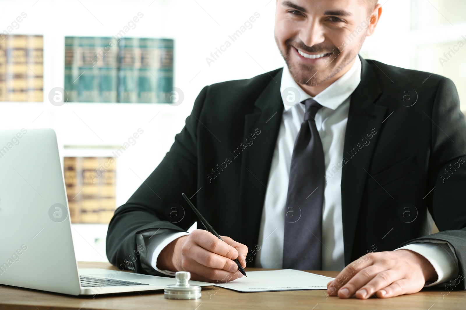 Photo of Male notary working with documents at table