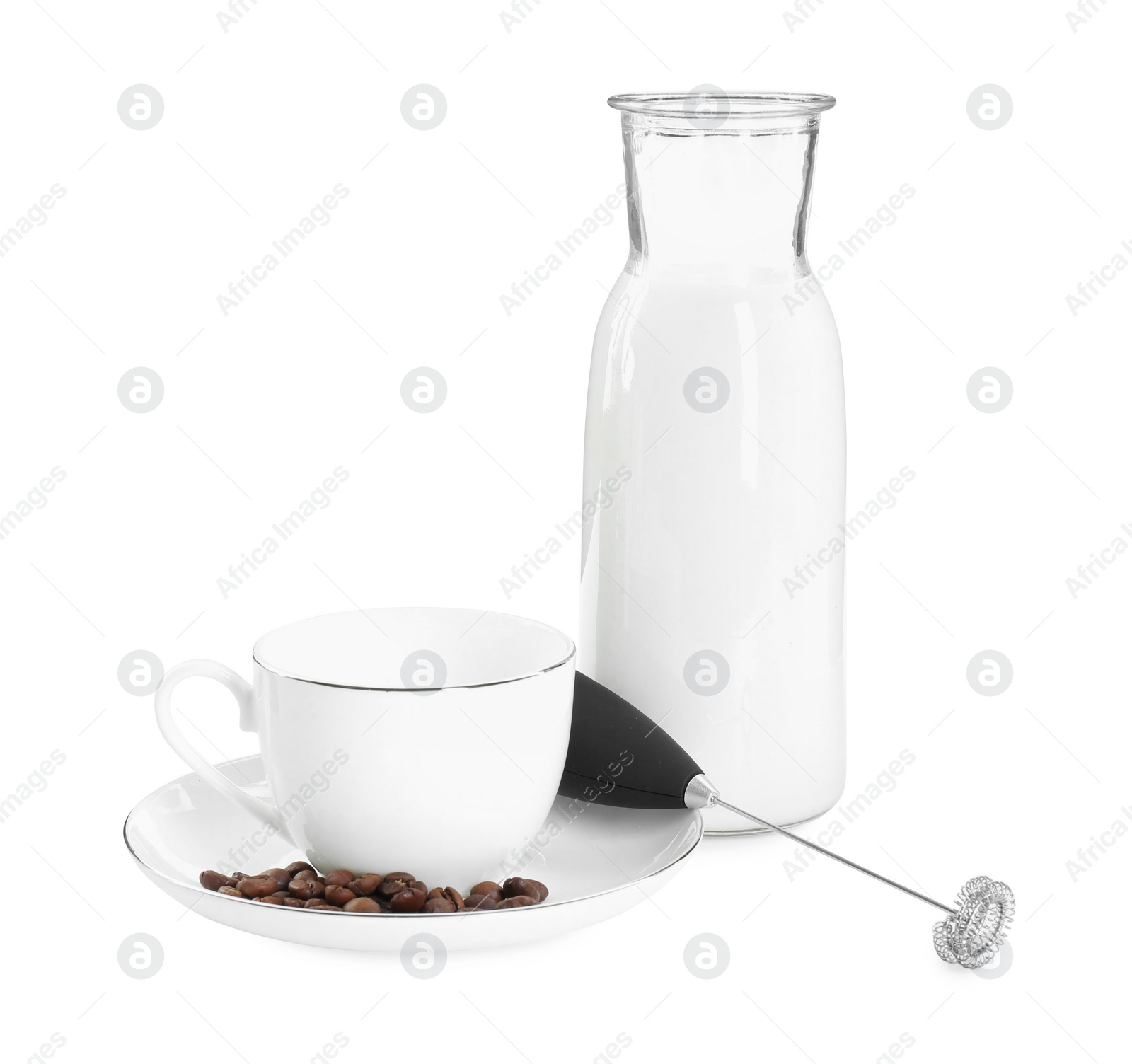 Photo of Mini mixer (milk frother), cup, coffee beans and bottle isolated on white