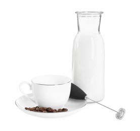 Photo of Mini mixer (milk frother), cup, coffee beans and bottle isolated on white