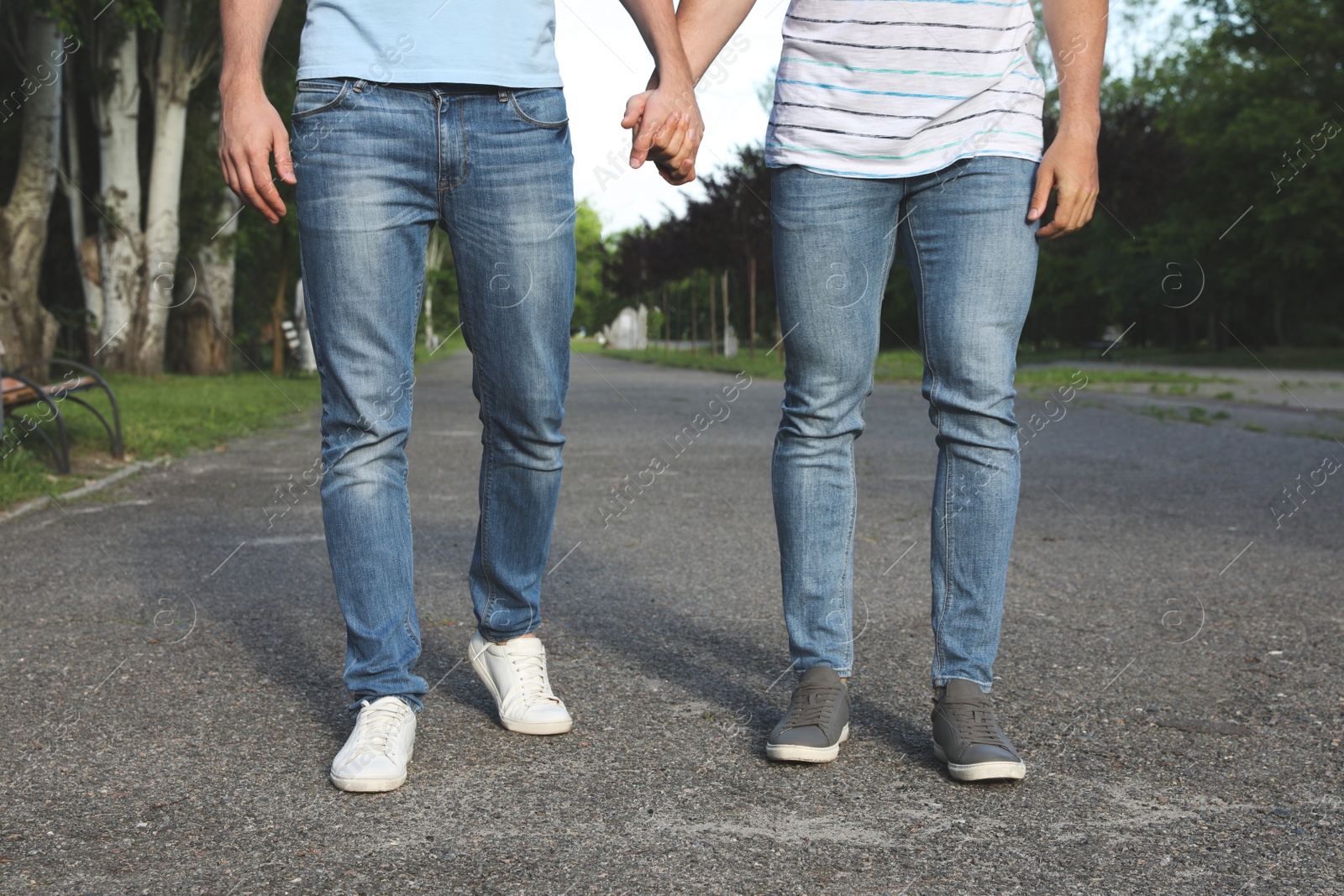 Photo of Gay couple walking in park on sunny day, closeup