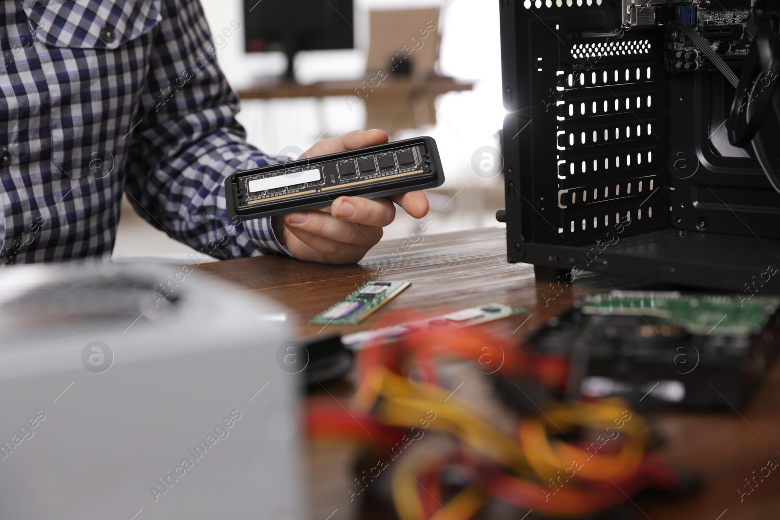 Photo of Male technician repairing computer at table, closeup