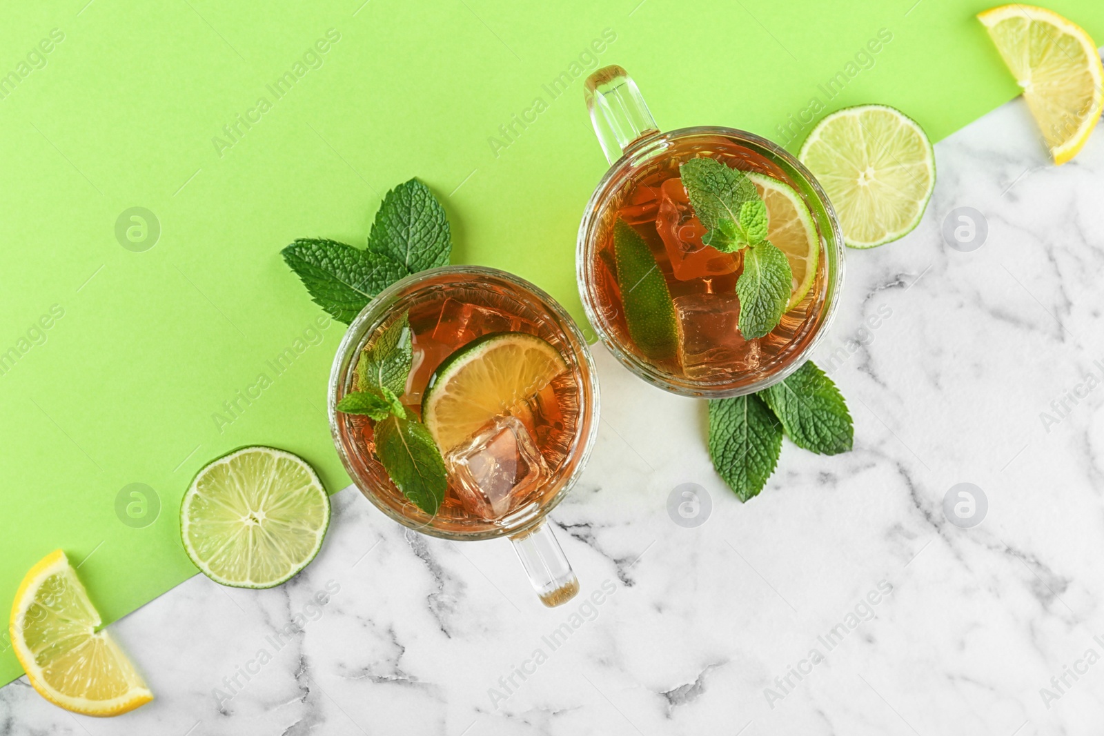 Photo of Flat lay composition with refreshing iced tea on table