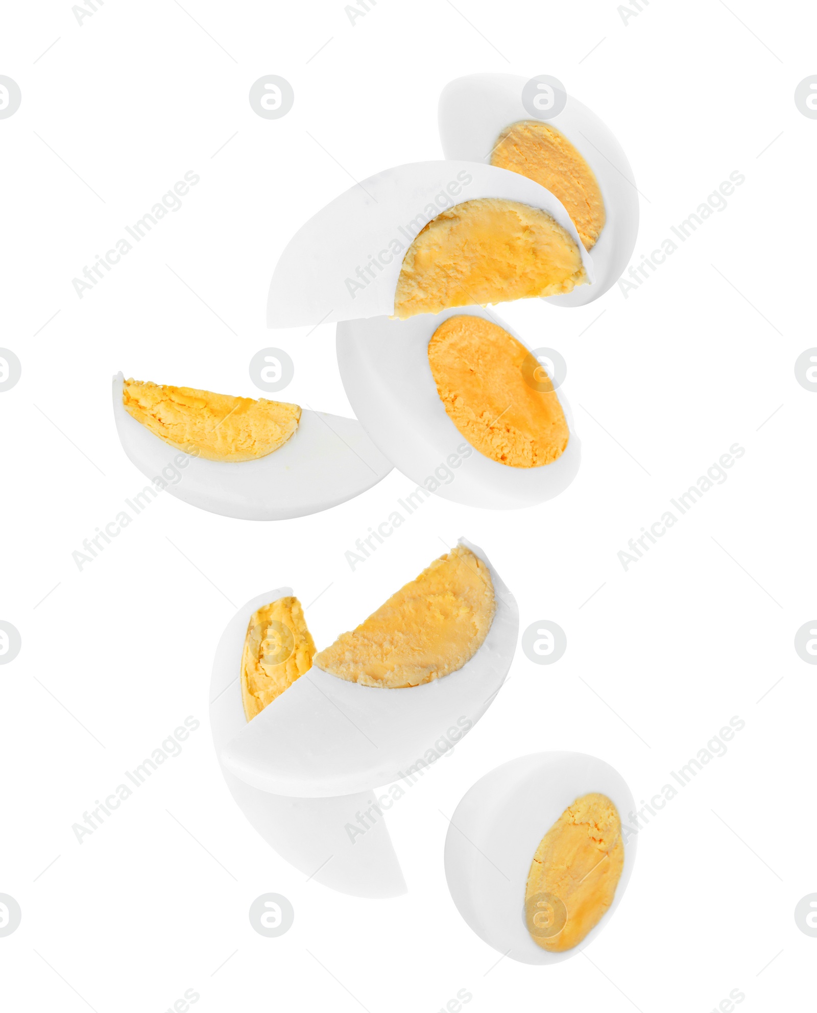 Image of Tasty hard boiled eggs falling on white background