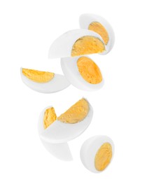 Image of Tasty hard boiled eggs falling on white background