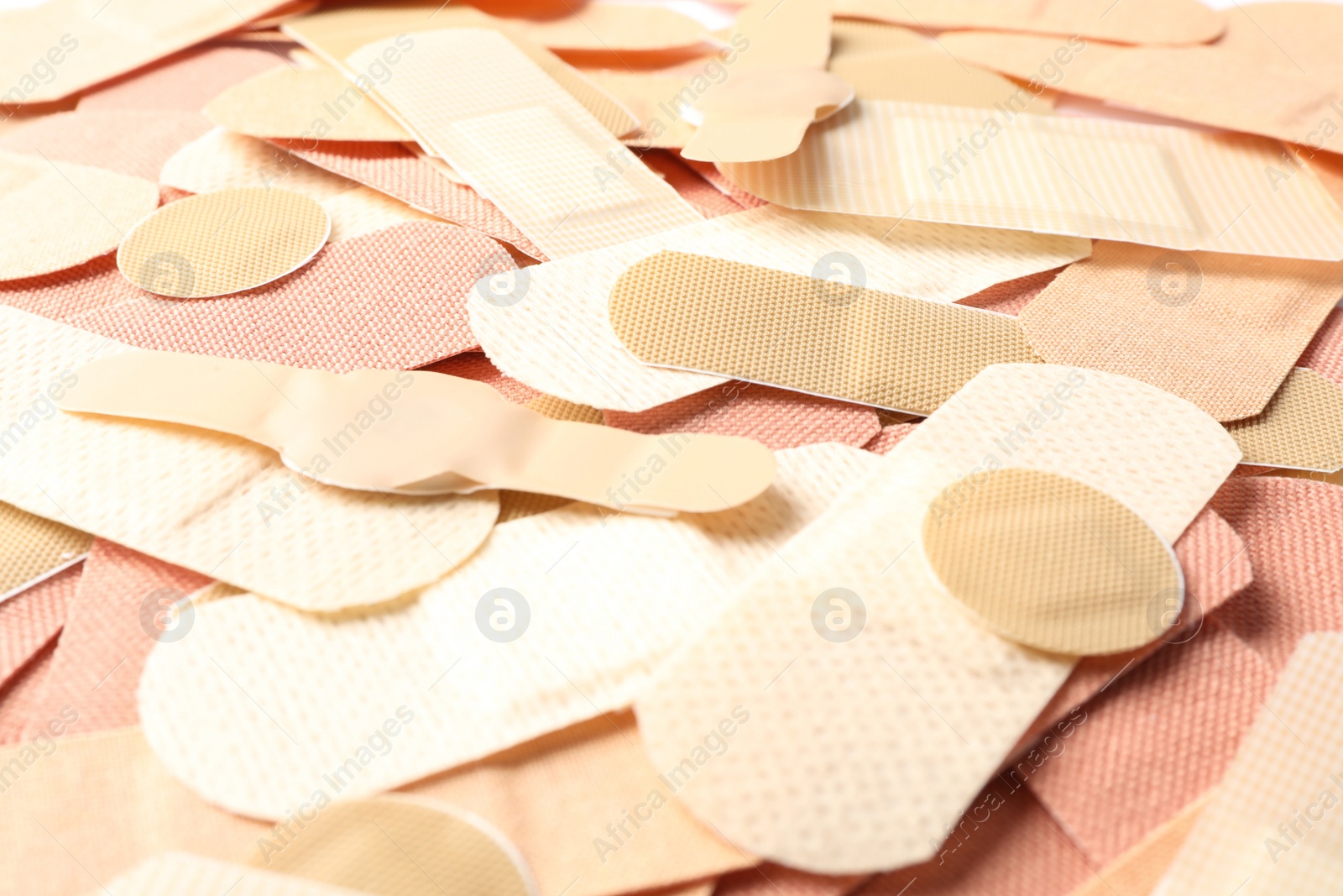 Different medical sticking plasters as background, closeup. First aid item Photo of Different medical sticking plasters as background, closeup. First aid item