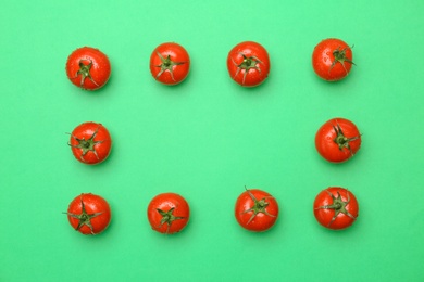 Photo of Frame made of ripe tomatoes on color background