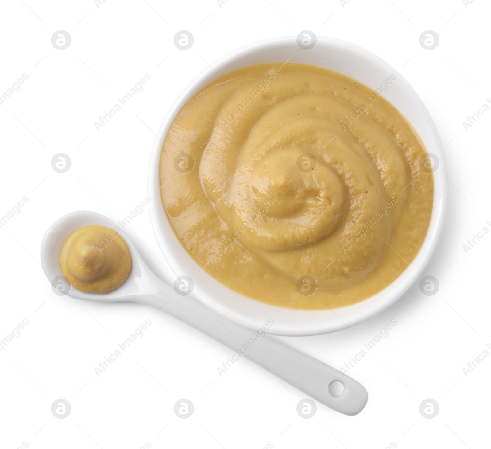 Photo of Fresh tasty mustard sauce in bowl and spoon isolated on white, top view