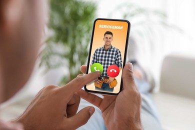 Image of Man with smartphone calling professional serviceman indoors, closeup