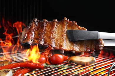 Image of Delicious ribs and vegetables on barbecue grill