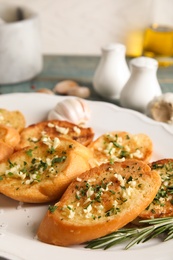 Plate with delicious homemade garlic bread, closeup. Space for text