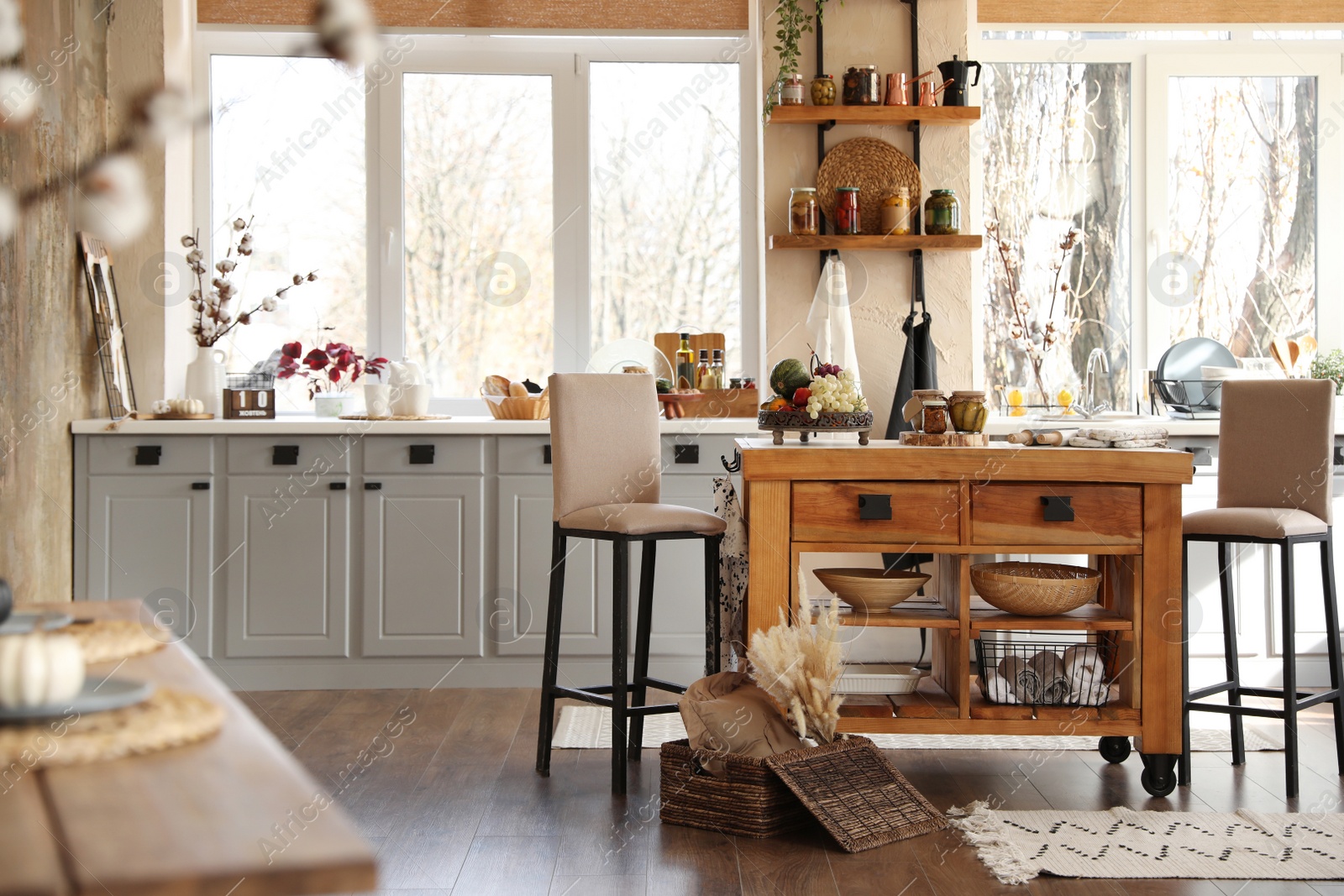 Photo of Stylish kitchen interior with wooden table and chairs