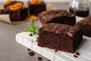 Wooden board with fresh brownies on table, space for text. Delicious chocolate pie