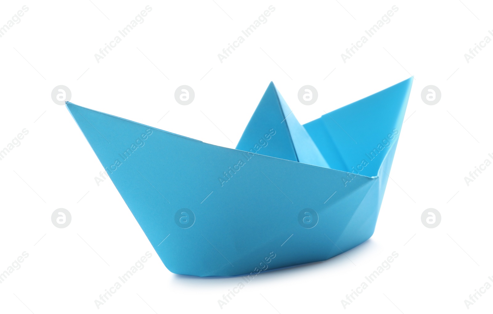 Photo of Handmade light blue paper boat isolated on white. Origami art