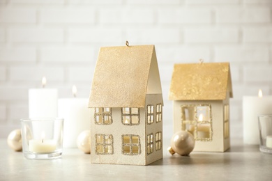 Composition with house shaped candle holders on light table. Christmas decoration